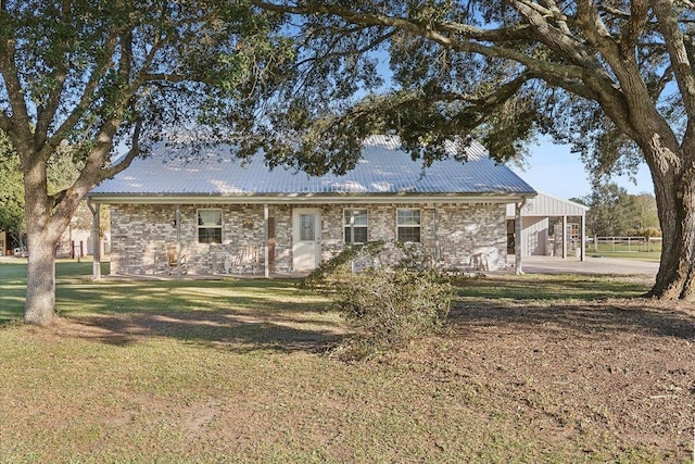 back of property featuring a yard and a carport