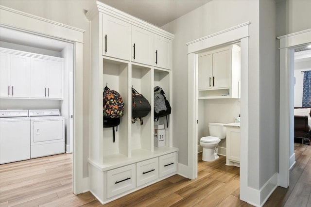 mudroom featuring separate washer and dryer and light hardwood / wood-style floors