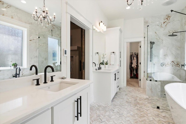 bathroom featuring a chandelier, vanity, and plus walk in shower