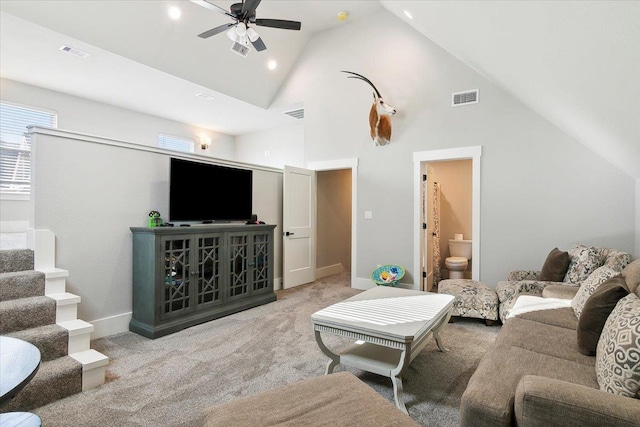 living room featuring light colored carpet, high vaulted ceiling, and ceiling fan