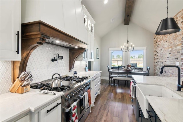 kitchen with white cabinets, pendant lighting, double oven range, and beamed ceiling