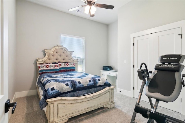 carpeted bedroom featuring ceiling fan and a closet