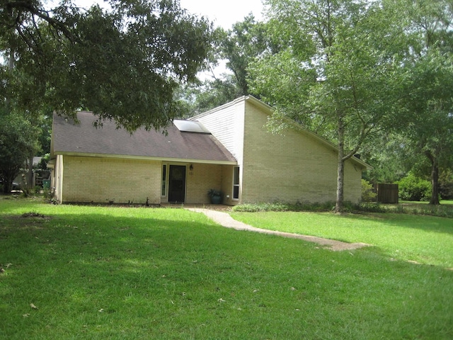 101 Locust Ln, Village Mills, TX 77663 - rear view of property with a yard and brick siding
