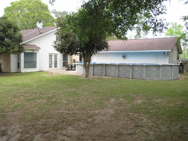 101 Locust Ln, Village Mills, TX 77663 - rear view of house featuring french doors, a yard, and an outdoor pool