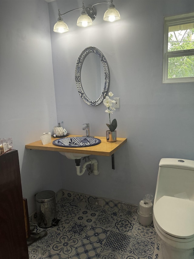 bathroom featuring tile patterned floors, sink, and toilet