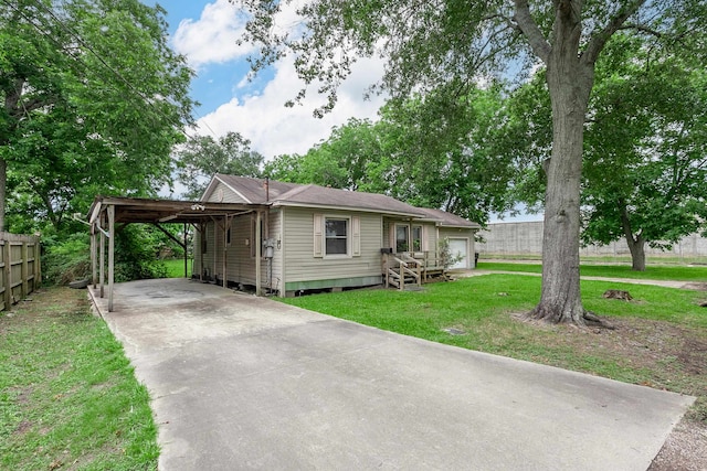 411 3rd St, Nederland, TX 77627 - view of front facade with driveway and a carport