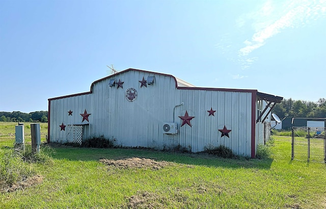 view of pole building featuring ac unit, a yard, and fence