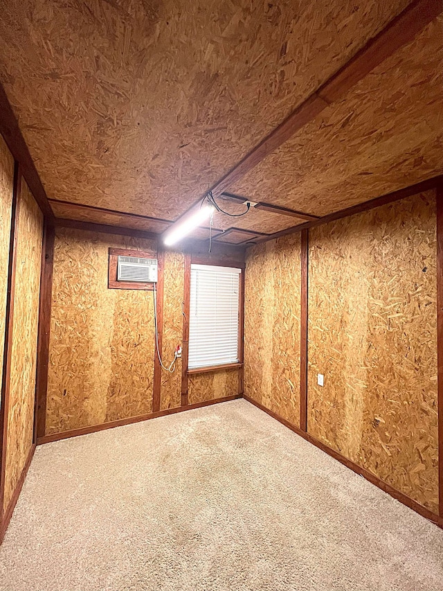 interior space featuring carpet and an AC wall unit