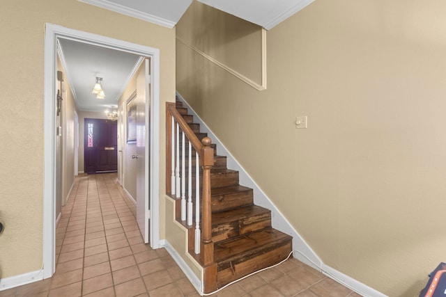 stairway featuring baseboards, ornamental molding, and tile patterned flooring