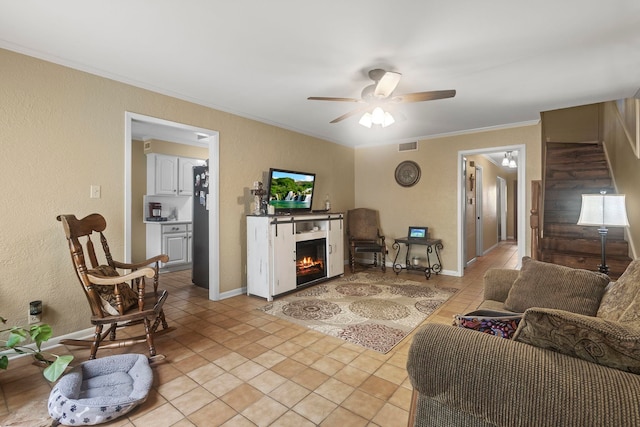 living room with crown molding, a textured wall, and ceiling fan