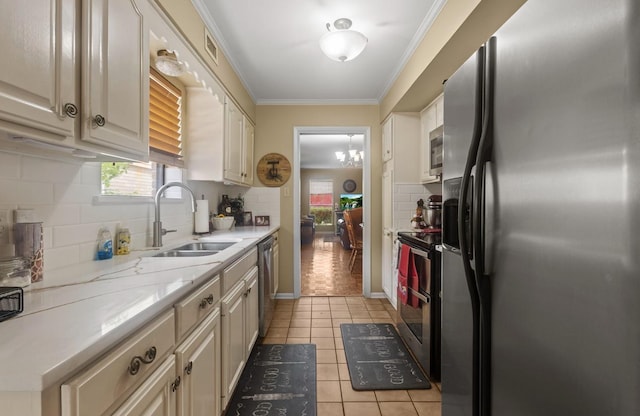 kitchen with a sink, stainless steel appliances, crown molding, backsplash, and light tile patterned flooring