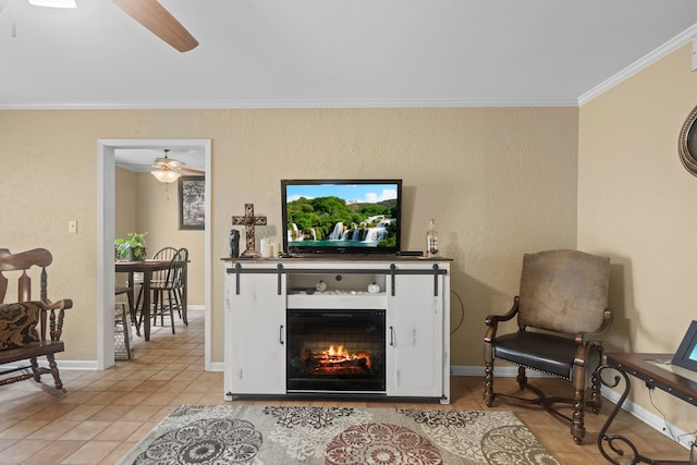 living area featuring crown molding, a ceiling fan, light tile patterned floors, a lit fireplace, and baseboards