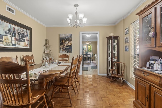 dining area featuring crown molding, visible vents, baseboards, and ceiling fan with notable chandelier