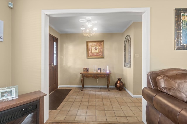 entrance foyer with ornamental molding, a notable chandelier, baseboards, and light tile patterned floors