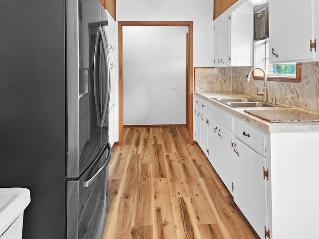 4296 W US Highway 190, Jasper, TX 75951 - kitchen featuring freestanding refrigerator, a sink, light wood-style floors, light countertops, and white cabinetry