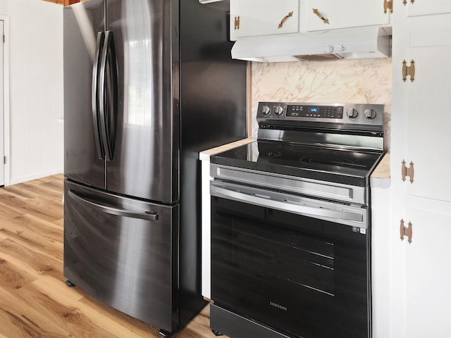 4296 W US Highway 190, Jasper, TX 75951 - kitchen with stainless steel appliances, under cabinet range hood, light wood-style flooring, and white cabinets