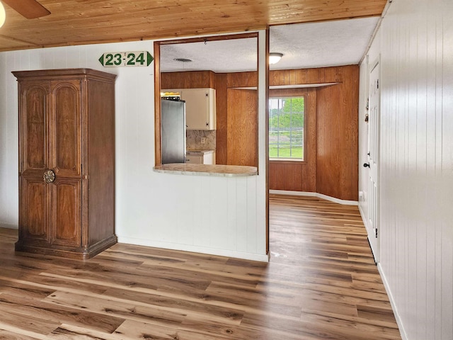 4296 W US Highway 190, Jasper, TX 75951 - spare room with wood finished floors, baseboards, and wood walls