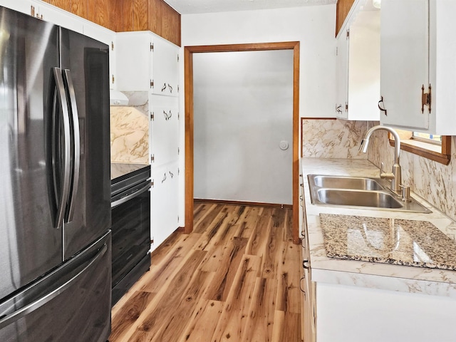 4296 W US Highway 190, Jasper, TX 75951 - kitchen with black appliances, a sink, light countertops, and light wood finished floors