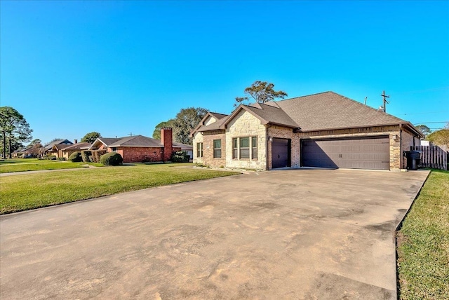 view of front of house with a front yard and a garage