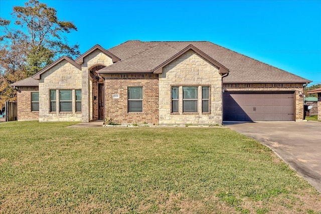 view of front of house featuring a garage and a front lawn