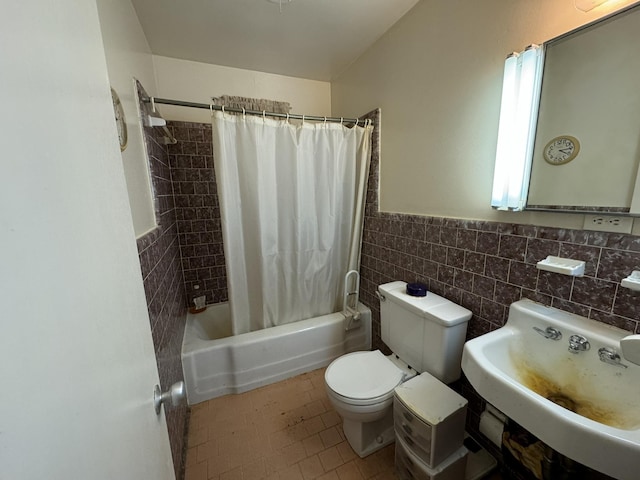 full bathroom with sink, shower / bath combination with curtain, tile walls, and toilet