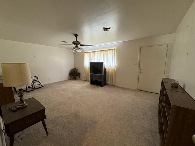 sitting room featuring light carpet and ceiling fan