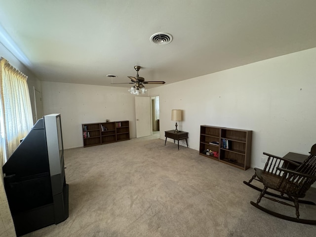 sitting room featuring carpet flooring and ceiling fan