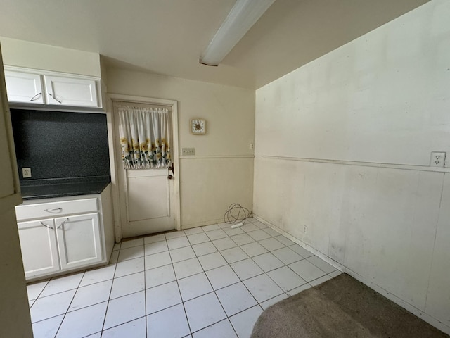 interior space featuring white cabinetry and light tile patterned floors