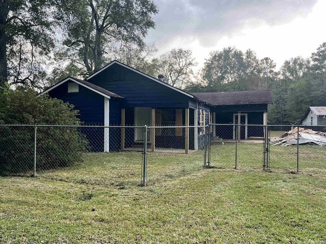 back of property featuring a lawn