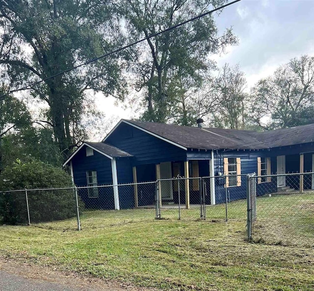 rear view of property with a lawn