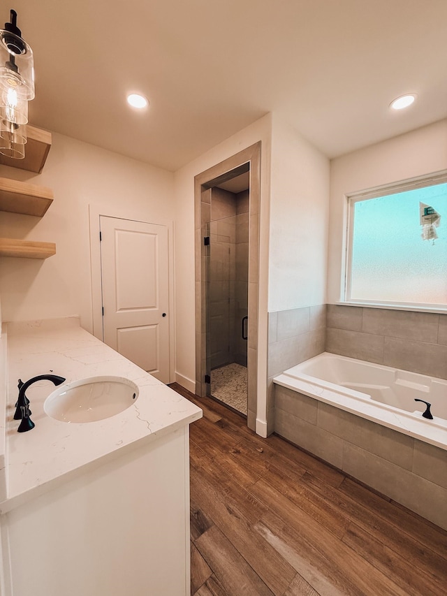 bathroom featuring vanity, wood-type flooring, and independent shower and bath