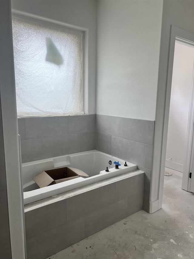 bathroom with tiled bath