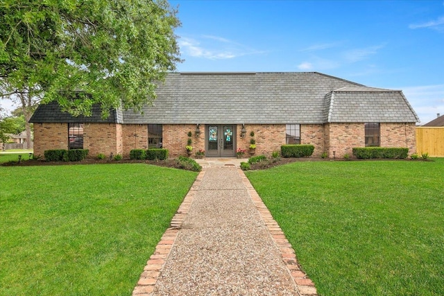 view of front facade with french doors and a front lawn