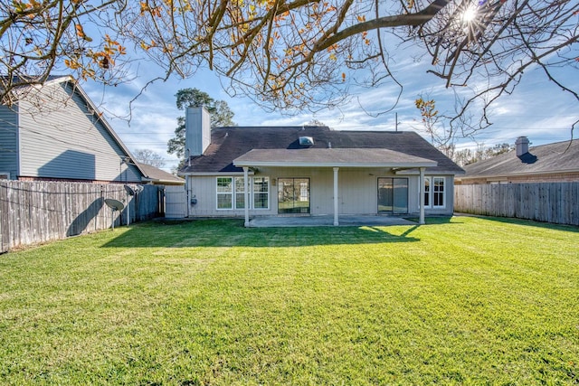 rear view of property with a patio area and a yard