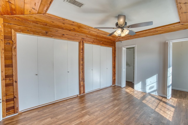 unfurnished bedroom featuring ceiling fan, lofted ceiling, hardwood / wood-style floors, and wooden ceiling