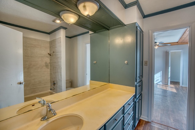 full bathroom with tiled shower / bath, wood-type flooring, vanity, ornamental molding, and ceiling fan