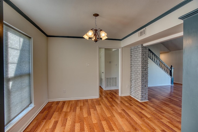 interior space featuring a chandelier, light hardwood / wood-style floors, and ornamental molding