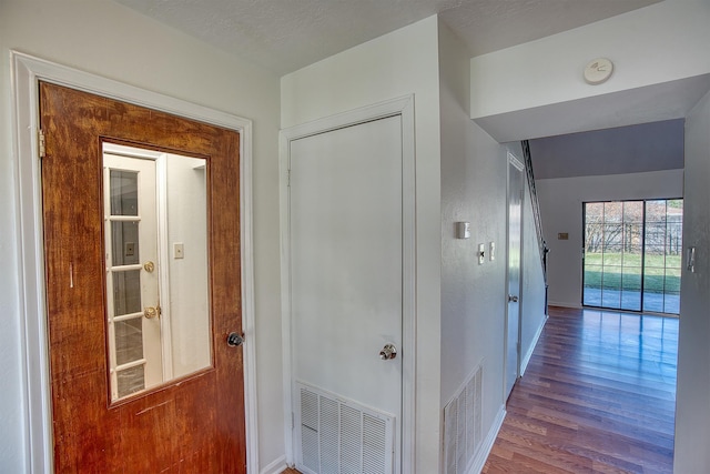 hallway featuring a textured ceiling and hardwood / wood-style floors