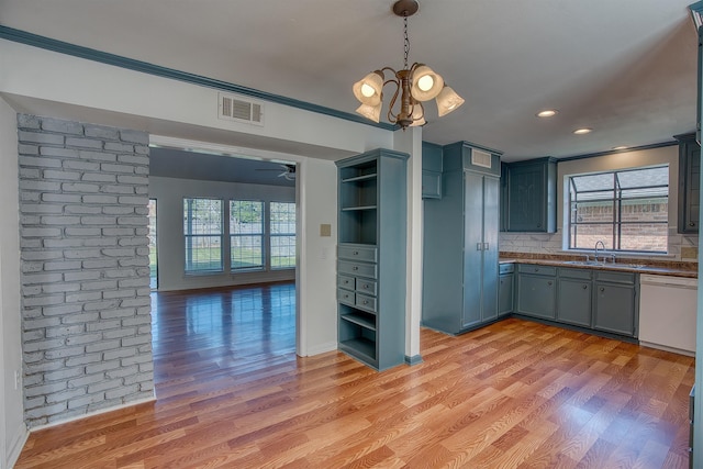 kitchen with white dishwasher, backsplash, light hardwood / wood-style flooring, and sink