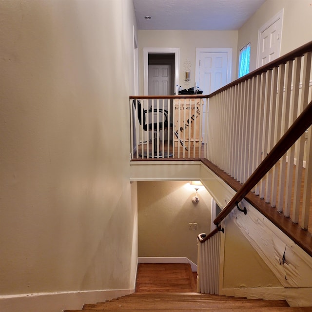 stairs featuring hardwood / wood-style flooring