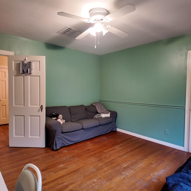 living room with ceiling fan and wood-type flooring