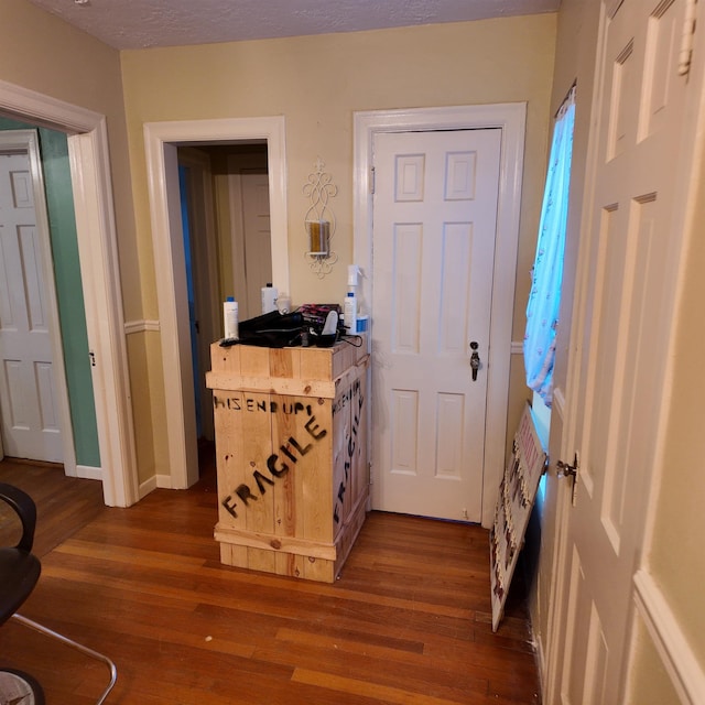 entryway with dark hardwood / wood-style flooring