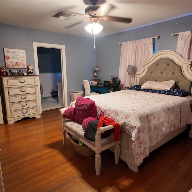 bedroom with hardwood / wood-style floors, ceiling fan, and ensuite bathroom