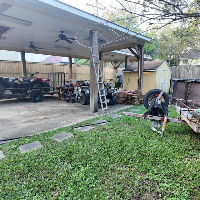 view of car parking with ceiling fan and a yard