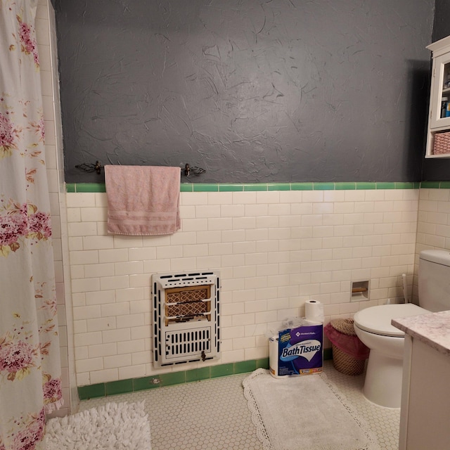 bathroom with vanity, tile patterned flooring, toilet, curtained shower, and heating unit