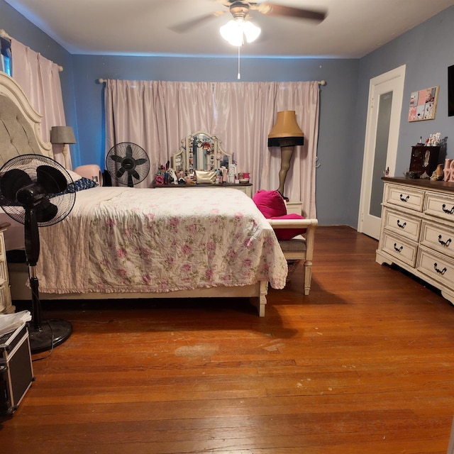 bedroom featuring ceiling fan and dark wood-type flooring