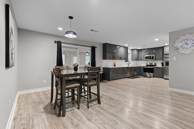 13370 Capital Dr, Bevil Oaks, TX 77713 - dining space featuring baseboards, light wood finished floors, and recessed lighting