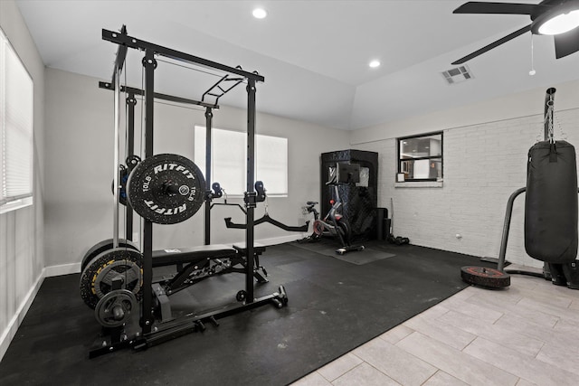 13370 Capital Dr, Bevil Oaks, TX 77713 - workout room featuring a ceiling fan, plenty of natural light, brick wall, vaulted ceiling, and recessed lighting