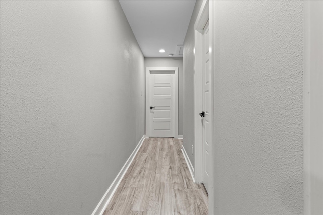 13370 Capital Dr, Bevil Oaks, TX 77713 - hall with a textured wall, light wood-style floors, baseboards, and recessed lighting