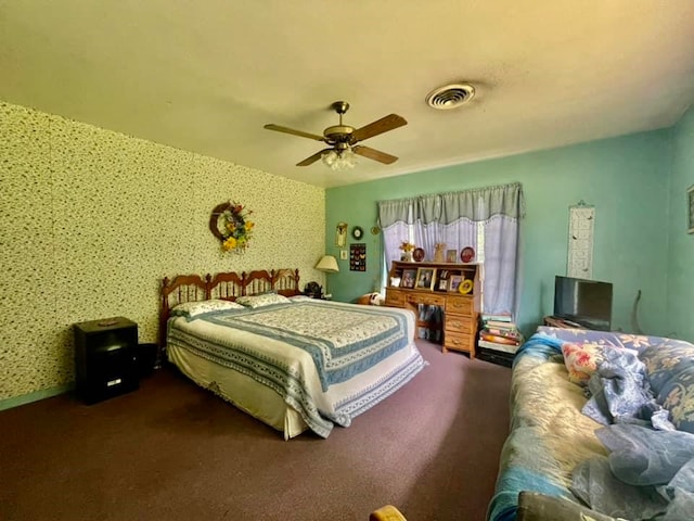 bedroom featuring ceiling fan and dark carpet